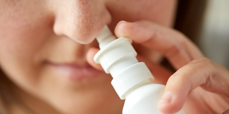 Une femme utilise un spray nasal